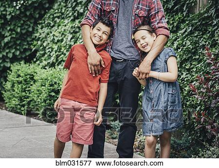 Mixed race brothers and sister hugging on suburban sidewalk View Large Photo Image Stock Photo - Mixed race brothers and sister hugging on suburban sidewalk. Fotosearch