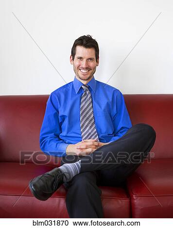 Mixed race businessman smiling on sofa View Large Photo Image Stock Image - Mixed race businessman smiling on sofa. Fotosearch