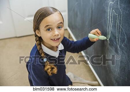 Stock Photo - Mixed race girl drawing on chalkboard. Fotosearch