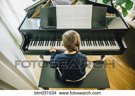 Mixed race girl playing piano View Large Photo Image Picture - Mixed race girl playing piano. Fotosearch