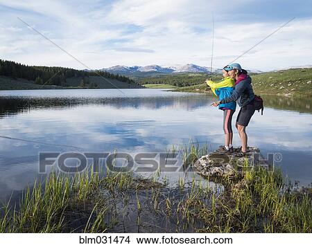 Mother and daughter fishing in river View Large Photo Image Picture - Mother and daughter fishing in river. Fotosearch