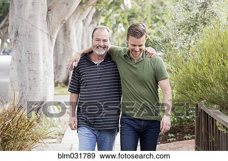 Older Caucasian man walking with son outdoors View Large Photo Image Stock Photo - Older Caucasian man walking with son outdoors. Fotosearch