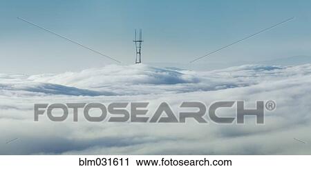 Stock Image - Power lines visible above clouds. Fotosearch