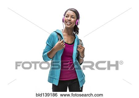 Stock Photograph - African American woman listening to headphones. Fotosearch