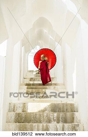 Asian Buddhist monk carrying umbrella on staircase at Hsinbyume Pagoda, Mandalay, Sagaing, Myanmar View Large Photo Image Stock Image - Asian Buddhist monk carrying umbrella on staircase at Hsinbyume Pagoda, Mandalay, Sagaing, Myanmar. Fotosearch