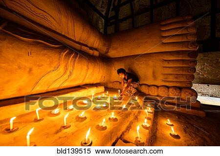 Asian girl lighting prayer candles in Buddhist temple View Large Photo Image Stock Photography - Asian girl lighting prayer candles in Buddhist temple. Fotosearch