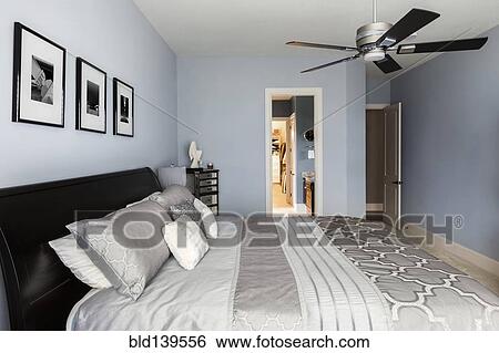 Bed, pictures and en suite bathroom of modern bedroom View Large Photo Image Stock Photograph - Bed, pictures and en suite bathroom of modern bedroom. Fotosearch