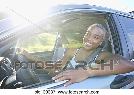 Stock Photo - Black woman driving car. Fotosearch