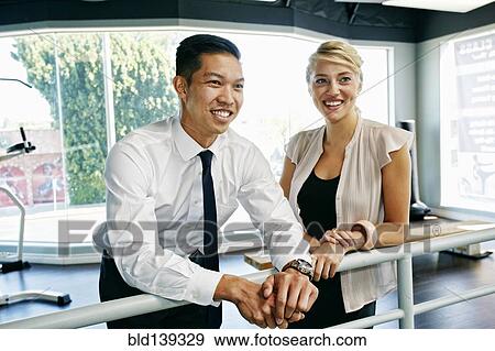 Stock Photo - Business people talking at railing. Fotosearch