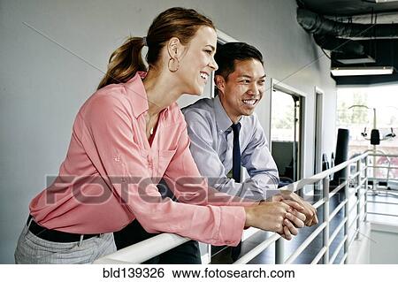 Business people talking at railing View Large Photo Image Stock Photograph - Business people talking at railing. Fotosearch