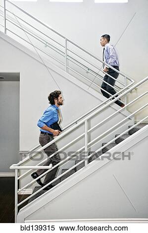 Stock Photography - Businessmen climbing staircase. Fotosearch
