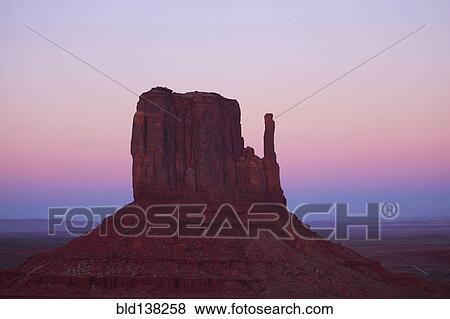 Butte rock formation in desert landscape, Monument Valley Tribal Park, Utah, United States View Large Photo Image Stock Photo - Butte rock formation in desert landscape, Monument Valley Tribal Park, Utah, United States. Fotosearch