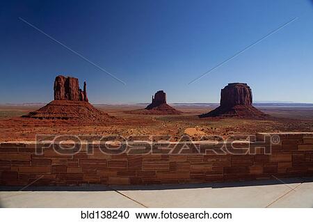 Stock Image - Butte rock formations in desert landscape, Monument Valley Tribal Park, Utah, United States. Fotosearch