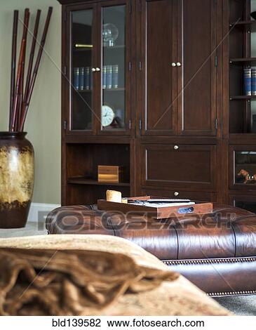 Cabinets, ottoman and tray in modern living room View Large Photo Image Stock Image - Cabinets, ottoman and tray in modern living room. Fotosearch