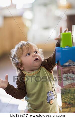 Stock Photo - Caucasian baby boy reaching for blocks. Fotosearch