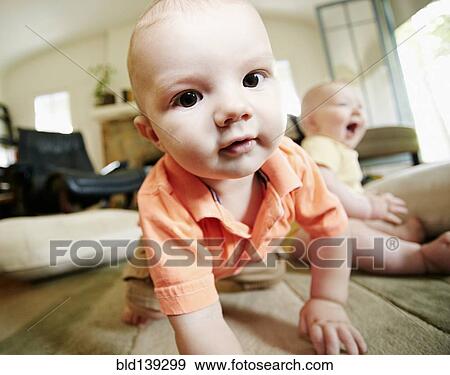 Caucasian baby crawling on living room floor View Large Photo Image Stock Photo - Caucasian baby crawling on living room floor. Fotosearch
