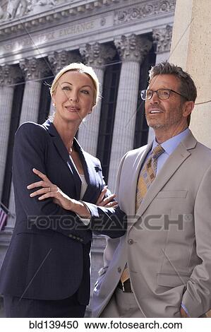 Stock Image - Caucasian business people standing in city, New York City, New York, United States. Fotosearch