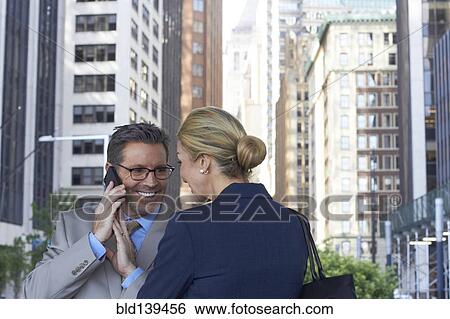Stock Photograph - Caucasian business people talking in city, New York City, New York, United States. Fotosearch
