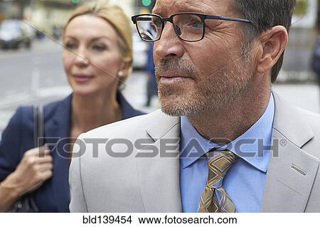 Picture - Caucasian business people walking in city, New York City, New York, United States. Fotosearch
