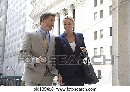 Stock Photo - Caucasian business people walking in city, New York City, New York, United States. Fotosearch