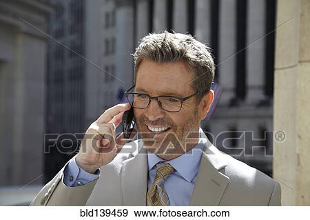 Caucasian businessman talking on cell phone in city, New York City, New York, United States View Large Photo Image Stock Photo - Caucasian businessman talking on cell phone in city, New York City, New York, United States. Fotosearch