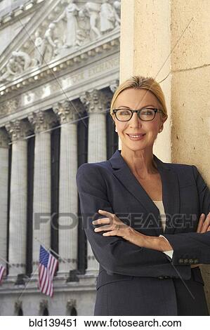 Stock Image - Caucasian businesswoman standing in city, New York City, New York, United States. Fotosearch