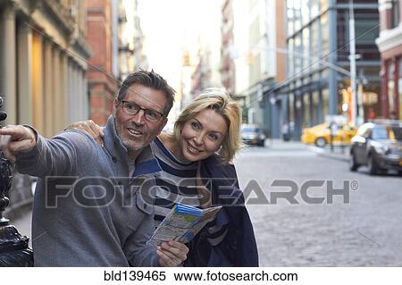 Caucasian couple holding map in city, New York City, New York, United States View Large Photo Image Stock Photography - Caucasian couple holding map in city, New York City, New York, United States. Fotosearch