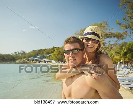 Caucasian couple hugging on beach View Large Photo Image Stock Photo - Caucasian couple hugging on beach. Fotosearch