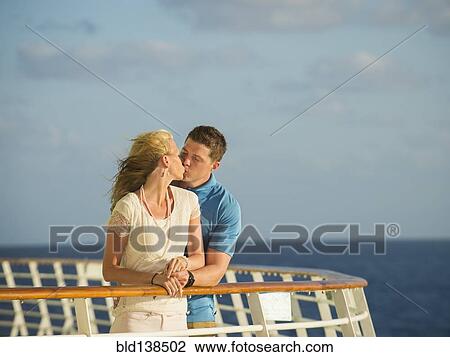 Caucasian couple kissing on boat deck View Large Photo Image Stock Image - Caucasian couple kissing on boat deck. Fotosearch