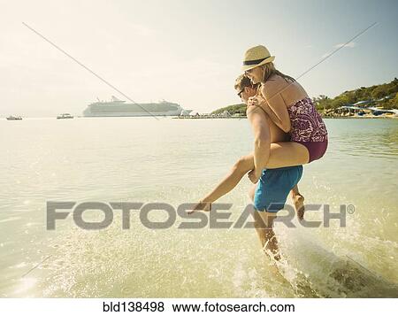 Caucasian couple playing in tropical ocean View Large Photo Image Stock Photo - Caucasian couple playing in tropical ocean. Fotosearch