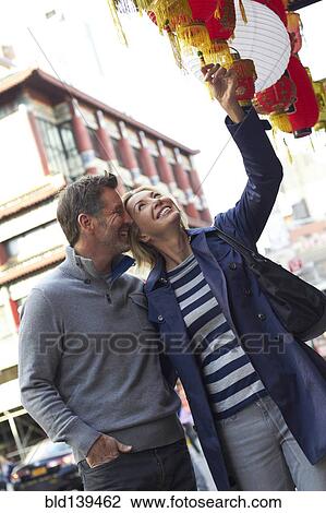 Stock Image - Caucasian couple shopping in Chinatown, New York City, New York, United States. Fotosearch