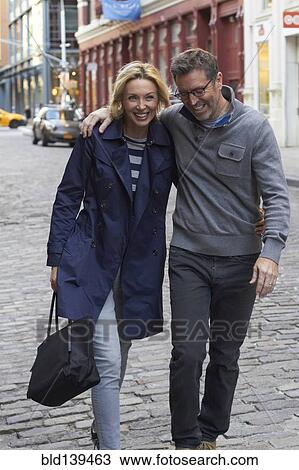Caucasian couple walking on city street, New York City, New York, United States View Large Photo Image Stock Image - Caucasian couple walking on city street, New York City, New York, United States. Fotosearch