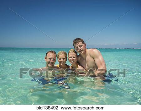 Caucasian couples smiling together in tropical ocean View Large Photo Image Stock Image - Caucasian couples smiling together in tropical ocean. Fotosearch