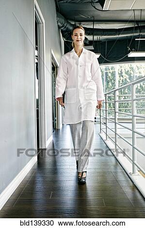Caucasian doctor smiling in corridor View Large Photo Image Stock Image - Caucasian doctor smiling in corridor. Fotosearch