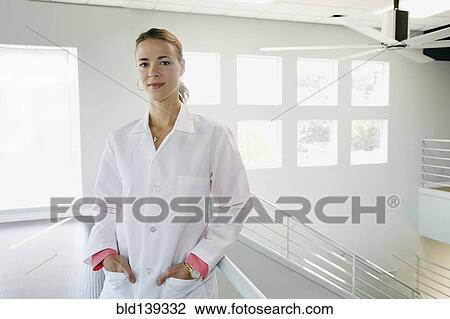 Caucasian doctor standing with hands in pockets near railing View Large Photo Image Stock Image - Caucasian doctor standing with hands in pockets near railing. Fotosearch