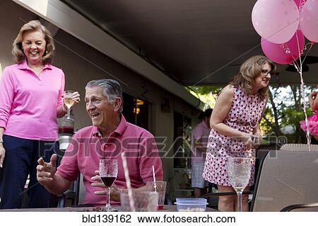 Stock Image - Caucasian family celebrating at party. Fotosearch