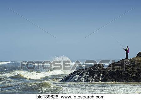 Caucasian fisherman holding fishing rod at rocky beach View Large Photo Image Stock Photograph - Caucasian fisherman holding fishing rod at rocky beach. Fotosearch