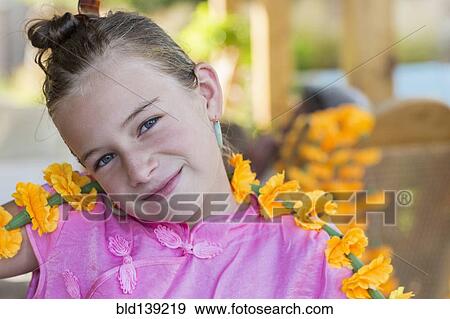 Stock Photo - Caucasian girl holding flower chain. Fotosearch