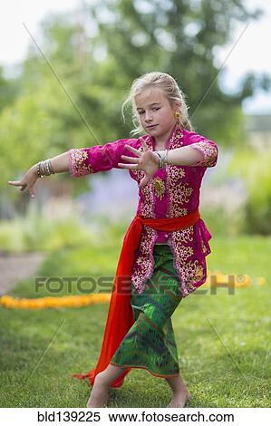 Caucasian girl performing Balinese dance in backyard View Large Photo Image Stock Photography - Caucasian girl performing Balinese dance in backyard. Fotosearch