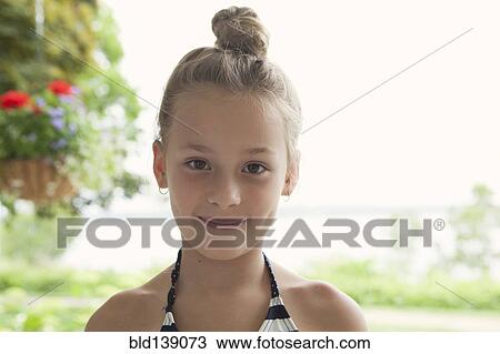 Stock Image - Caucasian girl smiling outdoors. Fotosearch