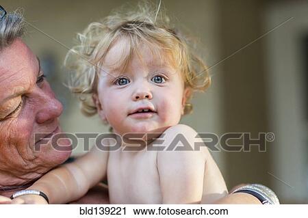 Caucasian grandmother holding grandson View Large Photo Image Stock Image - Caucasian grandmother holding grandson. Fotosearch