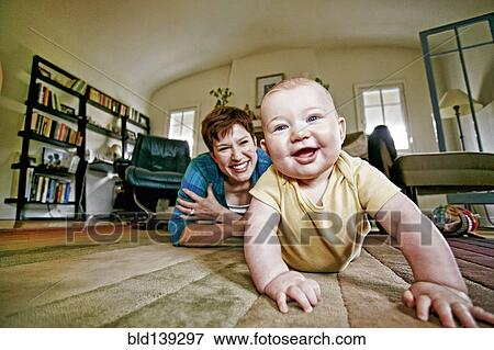 Caucasian mother and baby playing on living room floor View Large Photo Image Stock Photo - Caucasian mother and baby playing on living room floor. Fotosearch