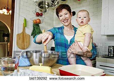 Caucasian mother cooking with baby in kitchen View Large Photo Image Stock Image - Caucasian mother cooking with baby in kitchen. Fotosearch