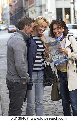 Caucasian tourists reading map on city street, New York City, New York, United States View Large Photo Image Stock Photo - Caucasian tourists reading map on city street, New York City, New York, United States. Fotosearch