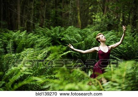 Caucasian woman dancing in forest View Large Photo Image Stock Image - Caucasian woman dancing in forest. Fotosearch