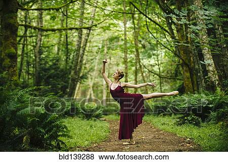 Caucasian woman dancing in forest View Large Photo Image Stock Photo - Caucasian woman dancing in forest. Fotosearch