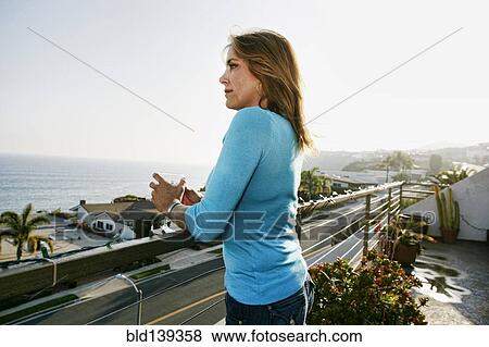 Caucasian woman drinking wine at waterfront View Large Photo Image Stock Photo - Caucasian woman drinking wine at waterfront. Fotosearch