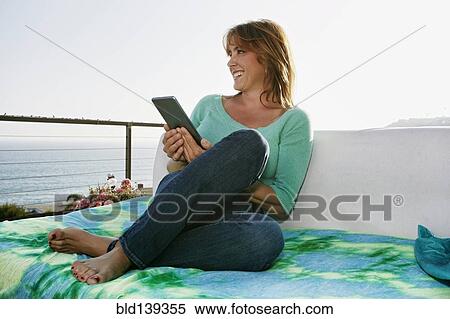 Caucasian woman using digital tablet at waterfront View Large Photo Image Stock Photography - Caucasian woman using digital tablet at waterfront. Fotosearch