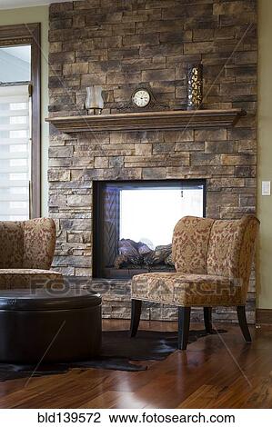 Chairs and fireplace in living room View Large Photo Image Stock Image - Chairs and fireplace in living room. Fotosearch