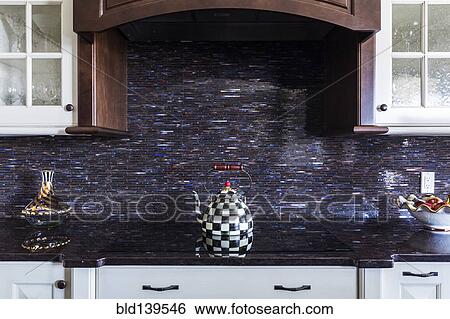Checkered teapot on stove in kitchen View Large Photo Image Stock Photograph - Checkered teapot on stove in kitchen. Fotosearch